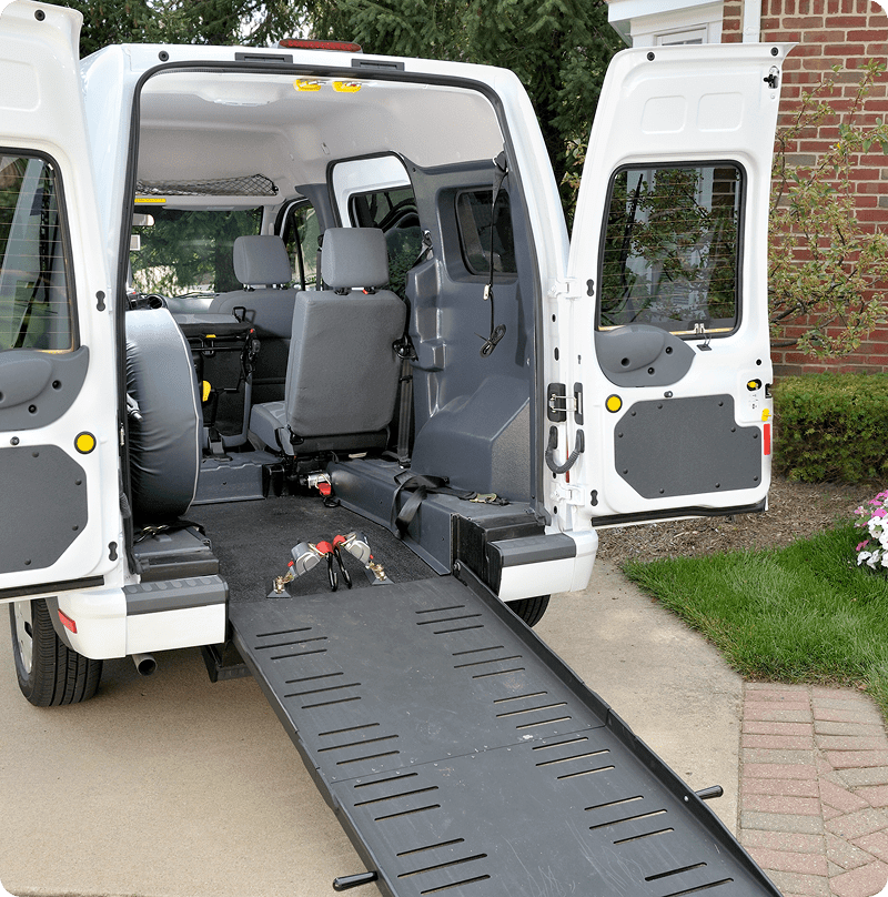 Van with wheelchair-accessible ramp extended.