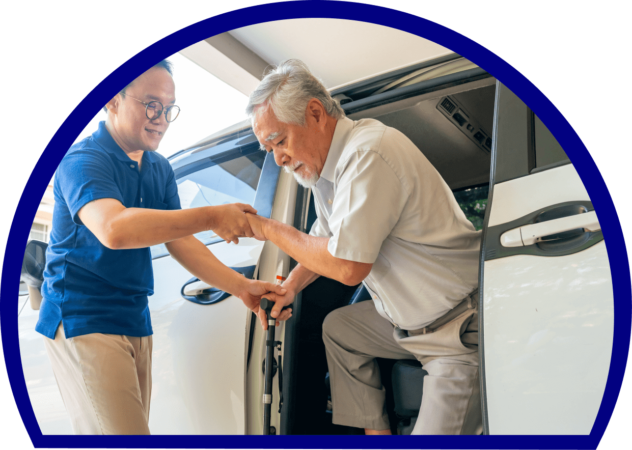 Young attendant supporting elderly man stepping out