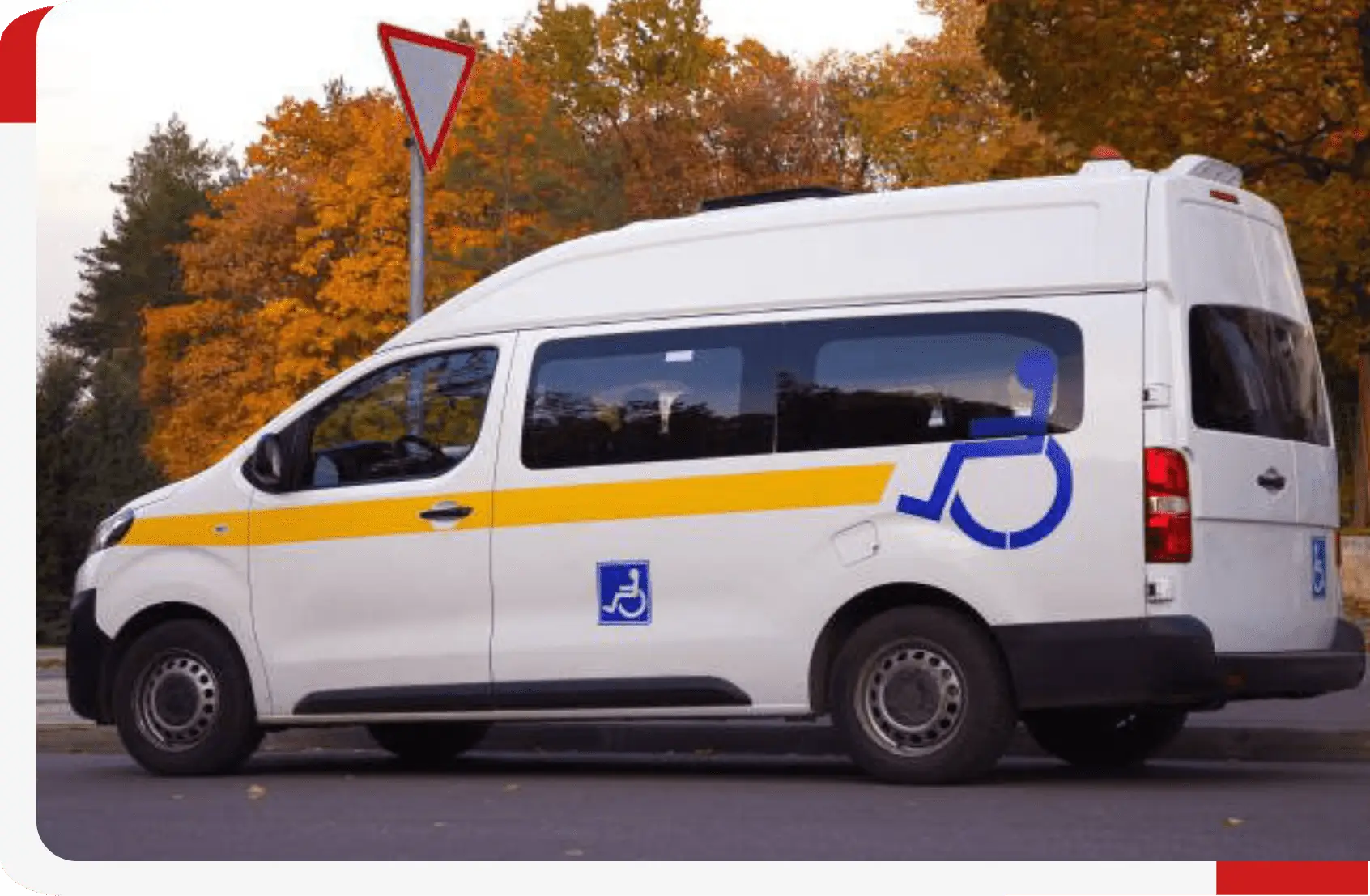 White accessible van with autumn trees background.
